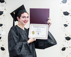 HiSET Graduate holding diploma